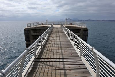 Pier over sea against sky