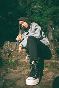 Full length of woman standing by tree