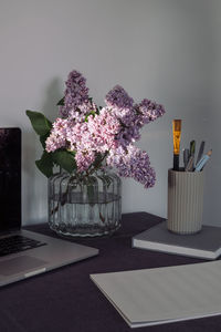 Close-up of purple flowering plant in vase on table