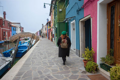 Rear view of woman walking on street