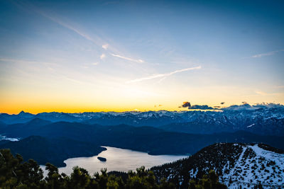 Scenic view of snowcapped mountains against sky during sunset