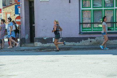 Rear view of people walking on road