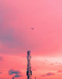 Low angle view of crane against sky during sunset