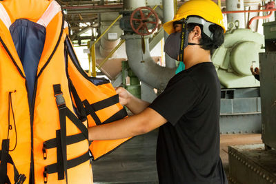 Rear view of man working in factory