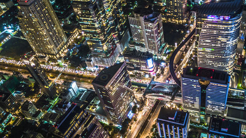 High angle view of illuminated buildings in city at night