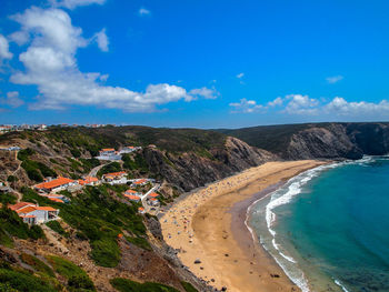 Scenic view of beach against blue sky
