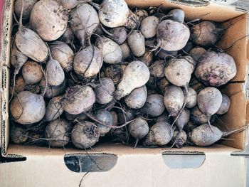 Directly above shot of beetroots in cardboard box