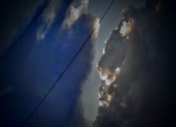 Low angle view of power lines against sky