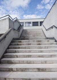 Low angle view of staircase by building against sky