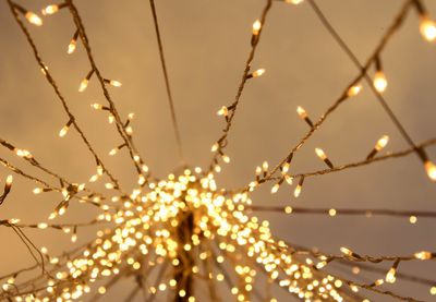 Low angle view of illuminated christmas lights against sky at night