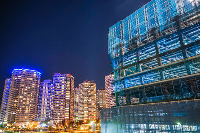 Illuminated buildings in city at night