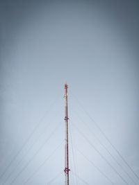 Low angle view of crane against clear blue sky