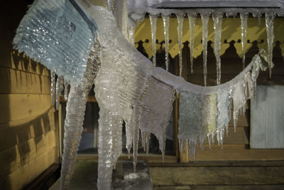 Panoramic view of icicles hanging from glass at night