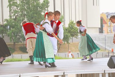 Rear view of women with arms raised