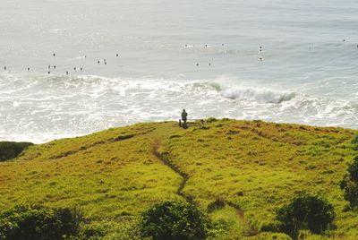 High angle view of man sitting on bench