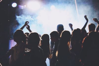 Rear view of people enjoying music concert