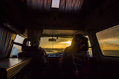 People sitting in car against sky