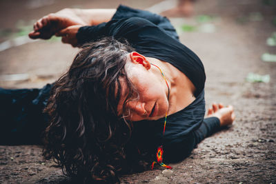Portrait of woman rolling on the floor. 