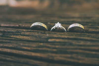 Close-up of wedding rings on wooden table