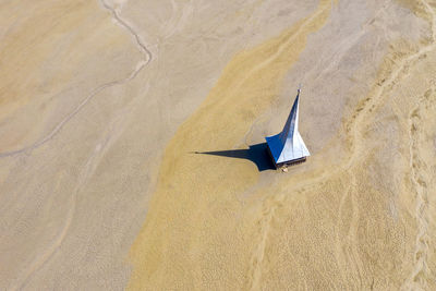 High angle view of umbrella on sand at beach