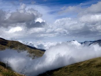 View of majestic mountain range against cloudy sky