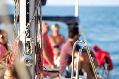 People sailing on sailboat in sea