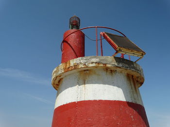 Low angle view of lighthouse against blue sky