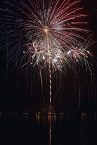 Low angle view of firework display at night