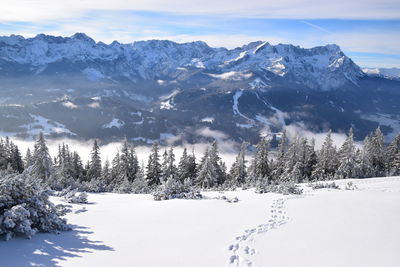 Scenic view of snow covered mountains against sky