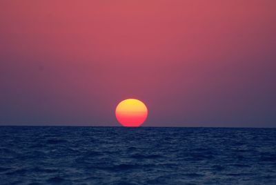 Scenic view of sea against romantic sky at sunset