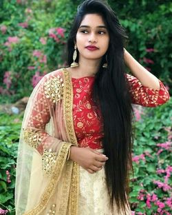 Portrait of a beautiful young woman standing outdoors