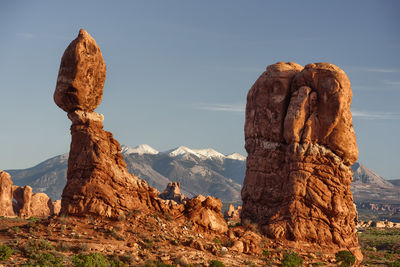 Rock formation on landscape against sky