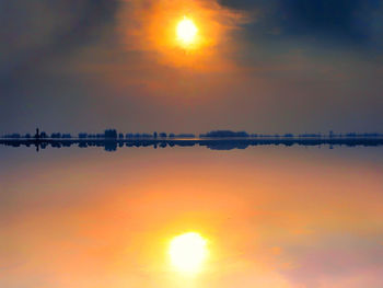 Scenic view of sunset over lake