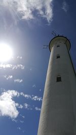 Low angle view of lighthouse against cloudy sky