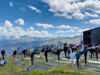 Yoga doing people on  field of a high mountain 