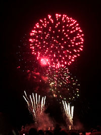 Low angle view of firework display at night