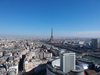 Aerial view of city buildings against clear blue sky