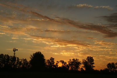 Low angle view of silhouette trees against sky during sunset