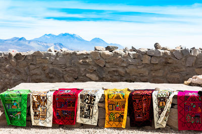 Clothes hanging on rock against sky