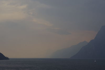 Scenic view of sea and mountains during sunset