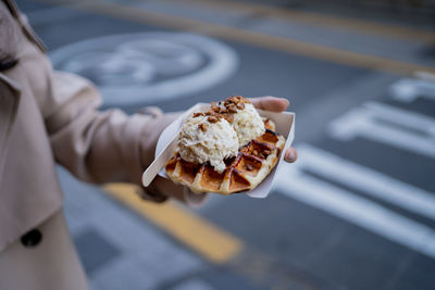 Midsection of person holding ice cream