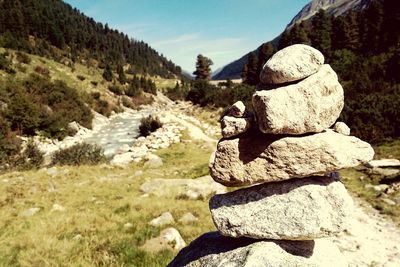 Close-up of rocks stacked at field