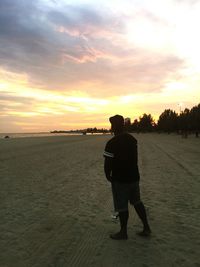 Rear view of man standing on beach