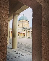 View of historical building seen through colonnade