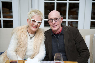 Portrait of mature couple sitting at table in house