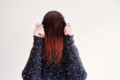 Portrait of beautiful woman against white background