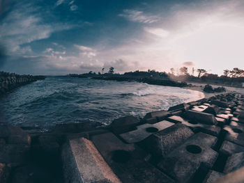 Seascape and concrete block against sky