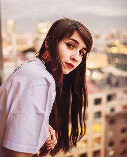 Portrait of beautiful young woman in city