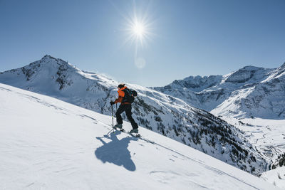 Rear view of man skiing on snowcapped mountain