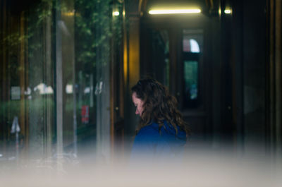 Woman looking through window